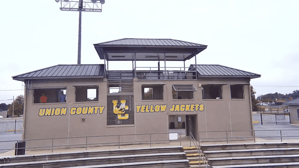 Awning windows installed in a stadium press box, offering clear, unobstructed views of the football field.